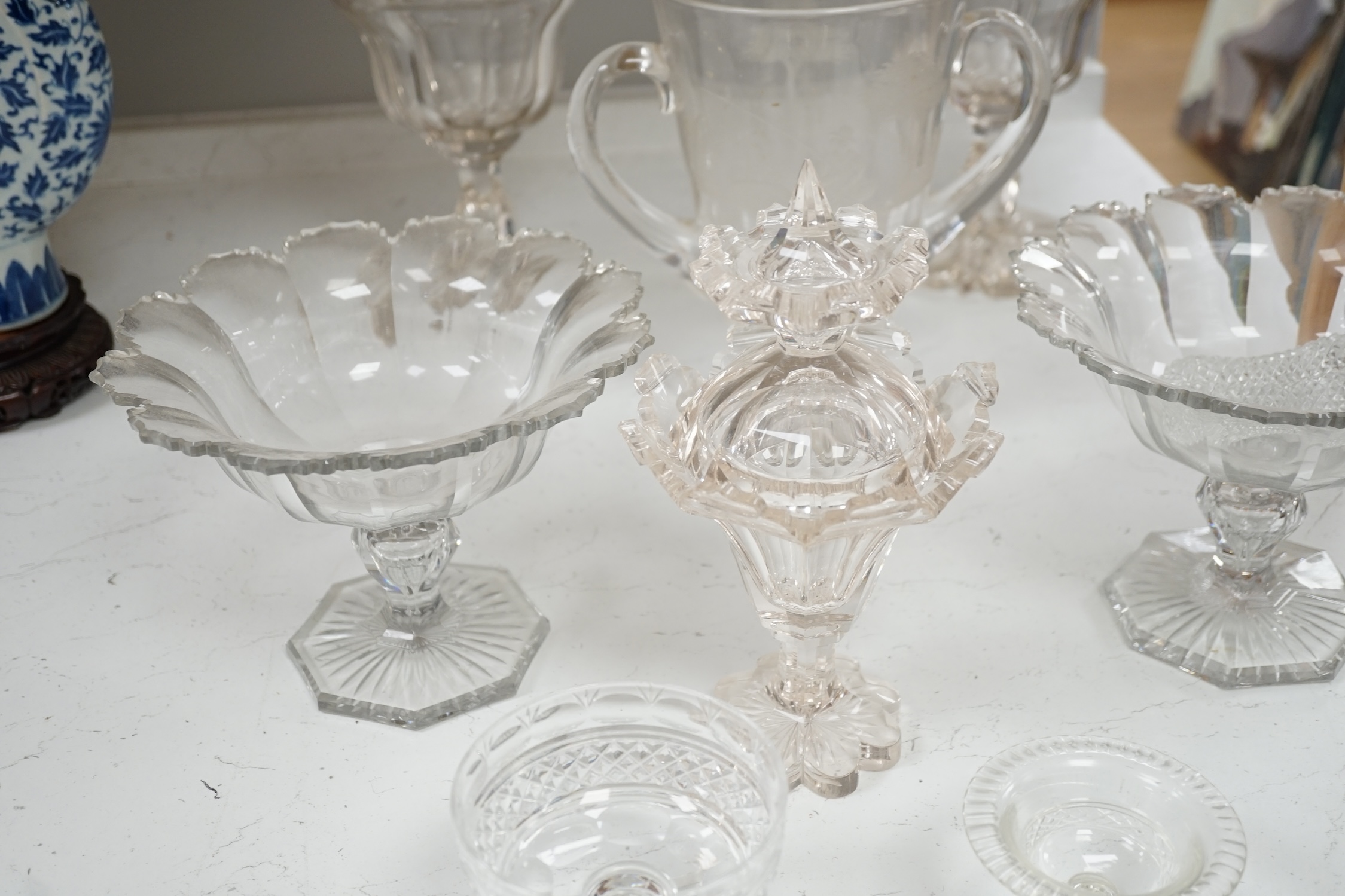 19th century and later glassware to include a pair of glass confitures (one cover), a twin handled etched cup, etc. largest 38cm high. Condition - fair